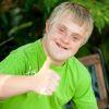 Bc23fc boy with downs syndrome giving thumbs up
