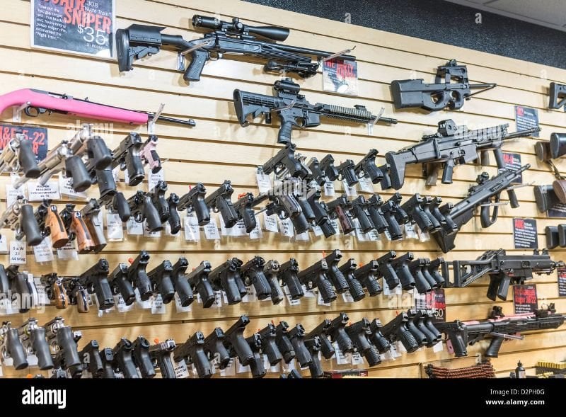 9cdab7 a large variety of guns rifles and weapons at a gun store d2ph0g